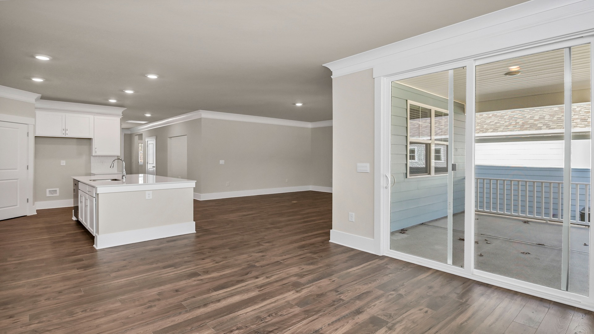 Back glass sliding doors in the dining room lead to the covered back patio