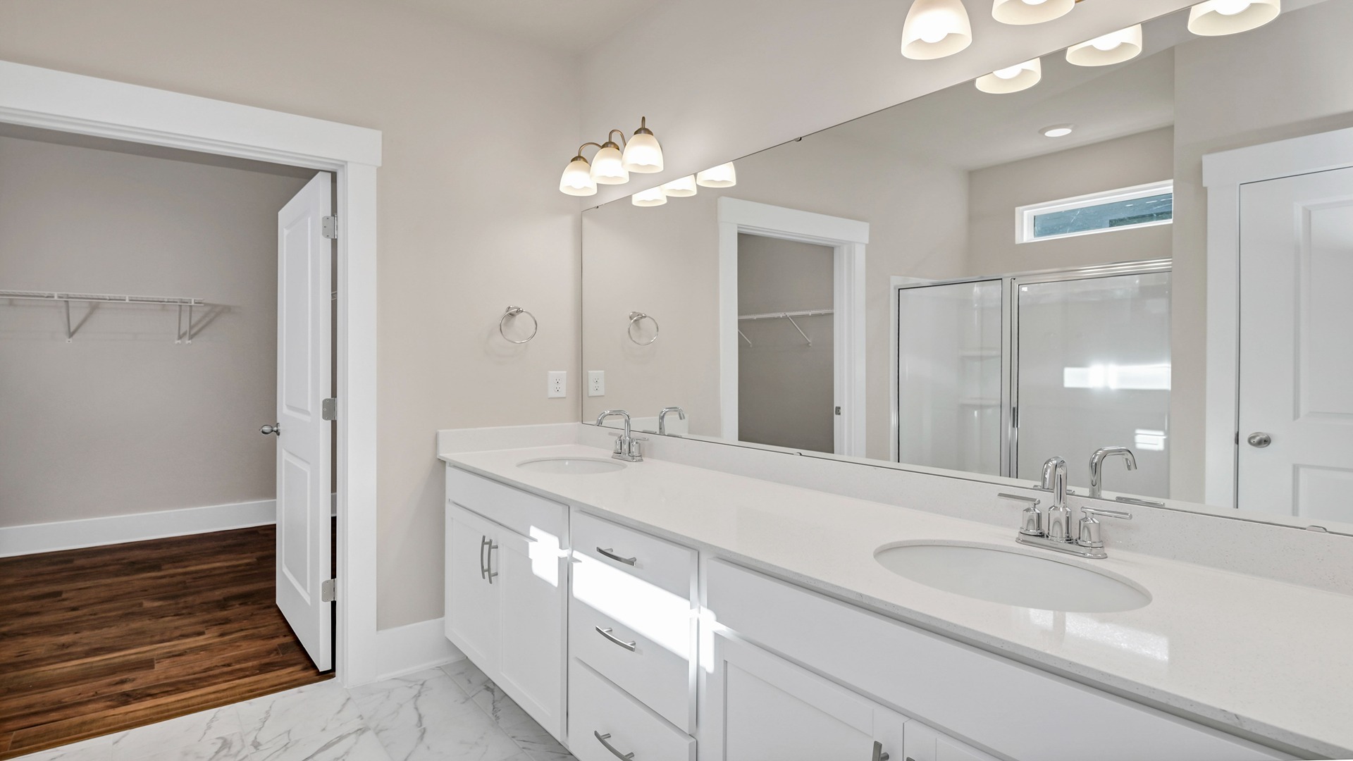Double primary bathroom vanity with two sinks and white quartz countertops