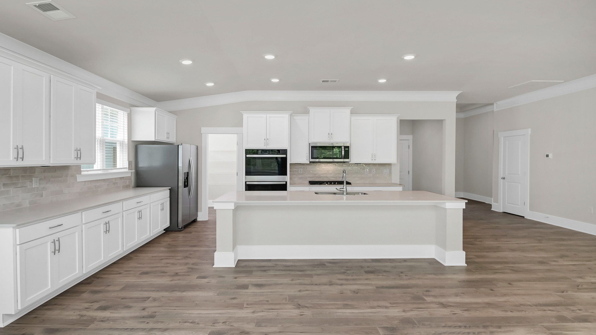 Open, large kitchen area in new home for sale with lots of countertop and cabinet space