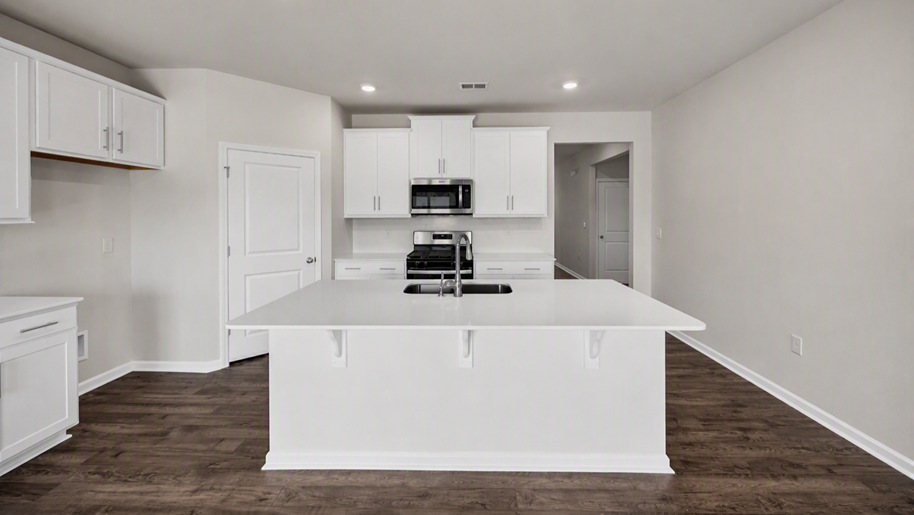 Front foyer of new construction home opens up into the modern kitchen area