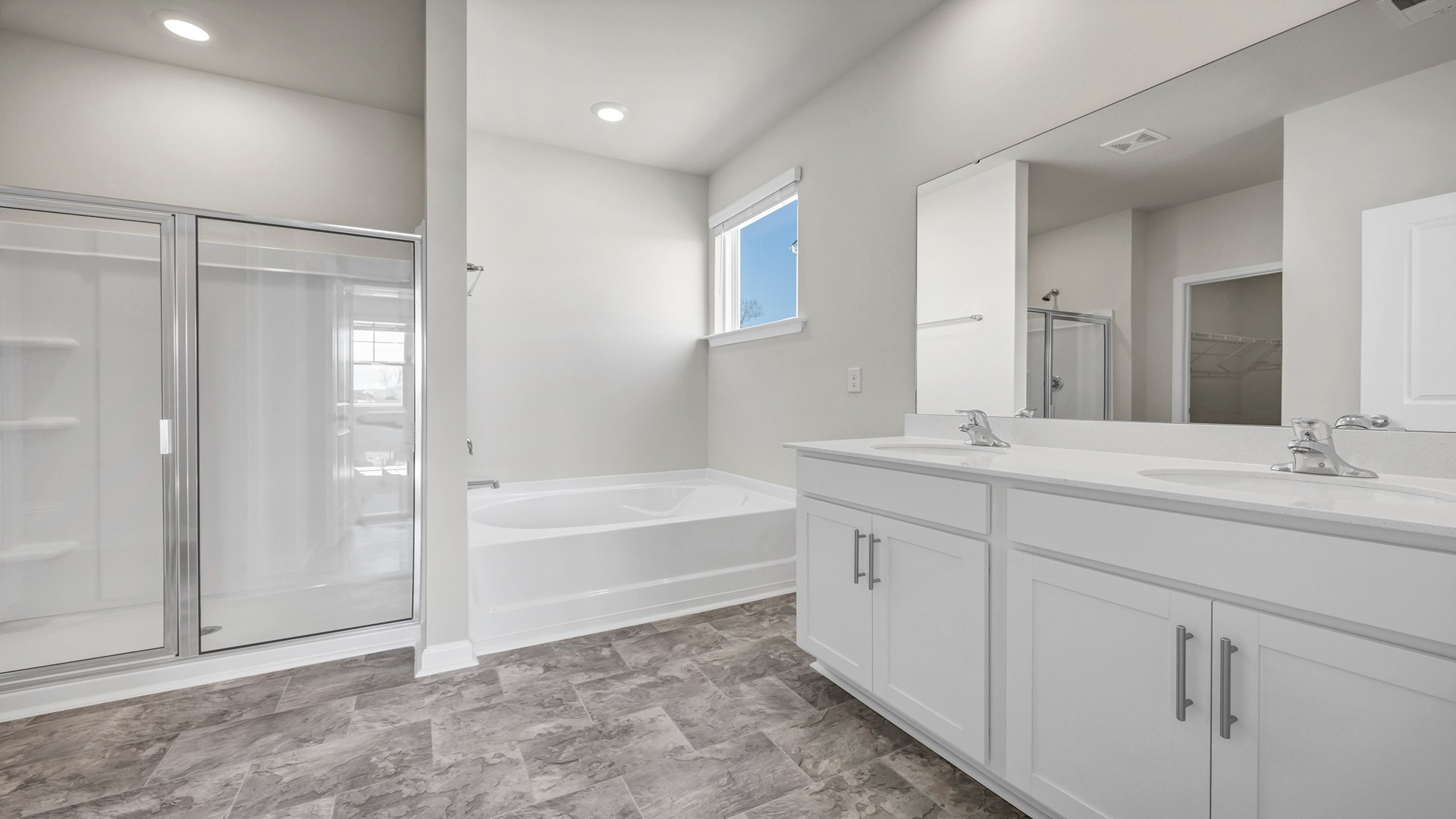 En-suite primary bathroom with shower and separate garden tub