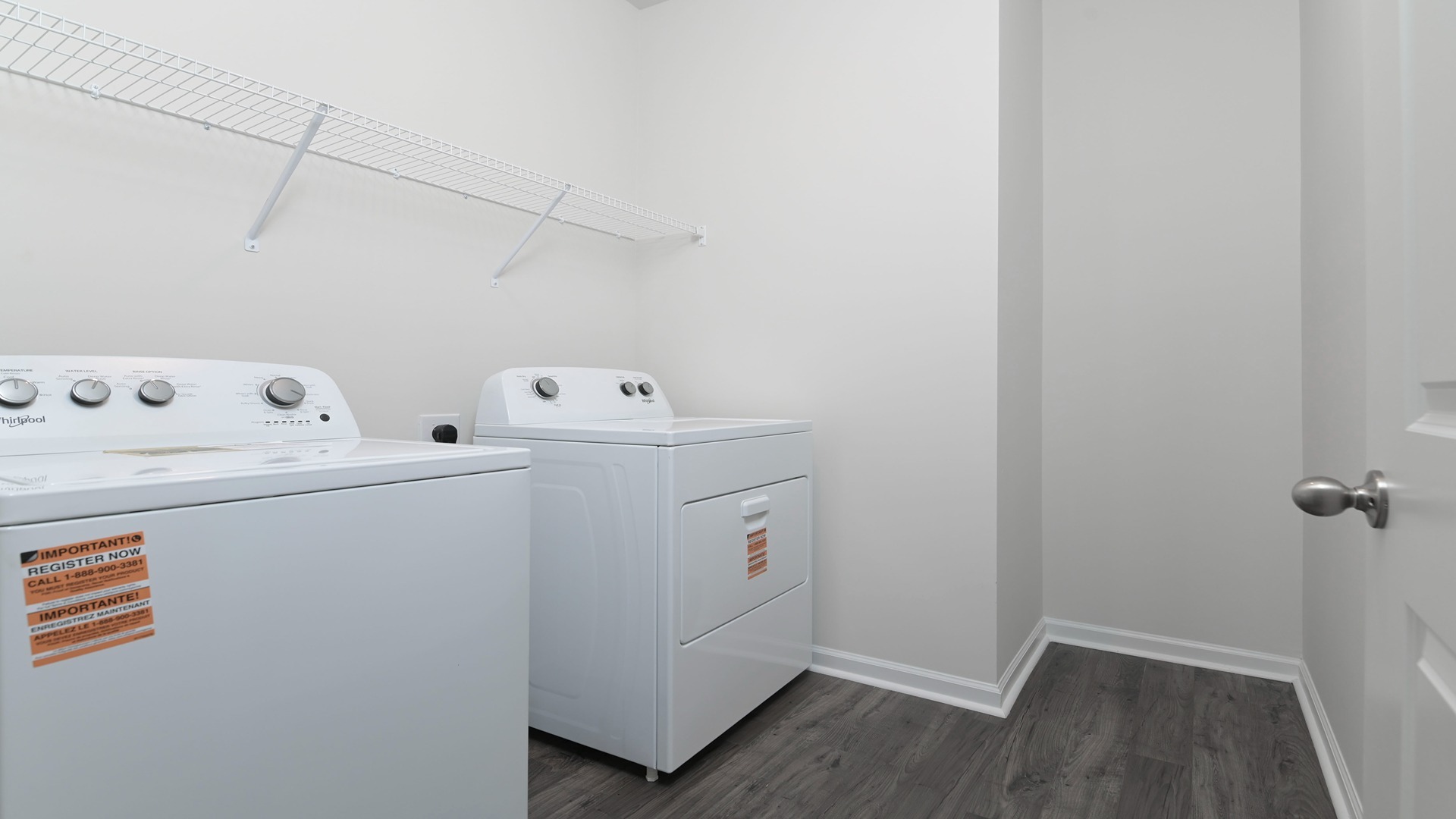 Centrally located laundry room with wire shelving and vinyl floors