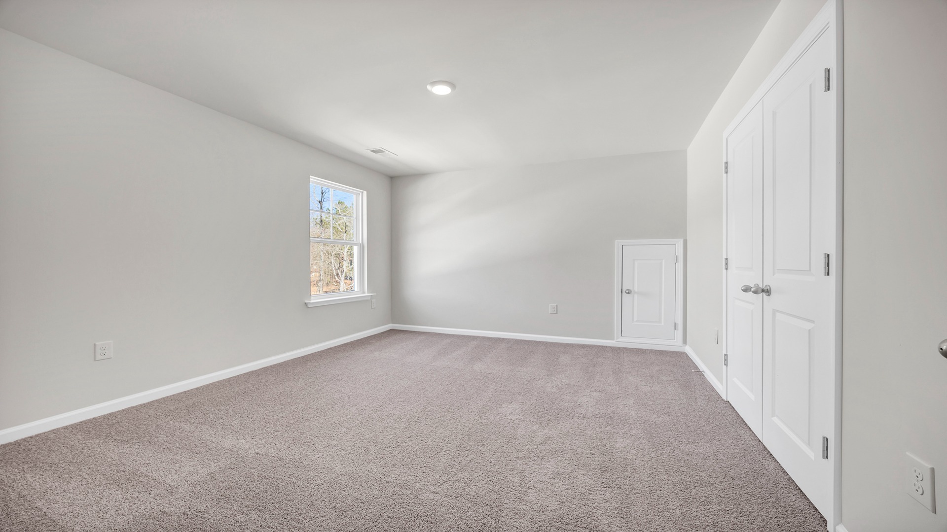 Bedroom 2 upstairs with carpet floors and a window for natural light