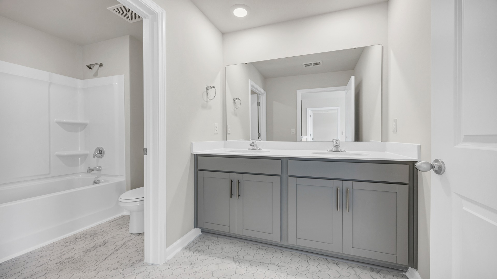 Bathroom 2 upstairs in the Manning floor plan with a double vanity and shower tub combo