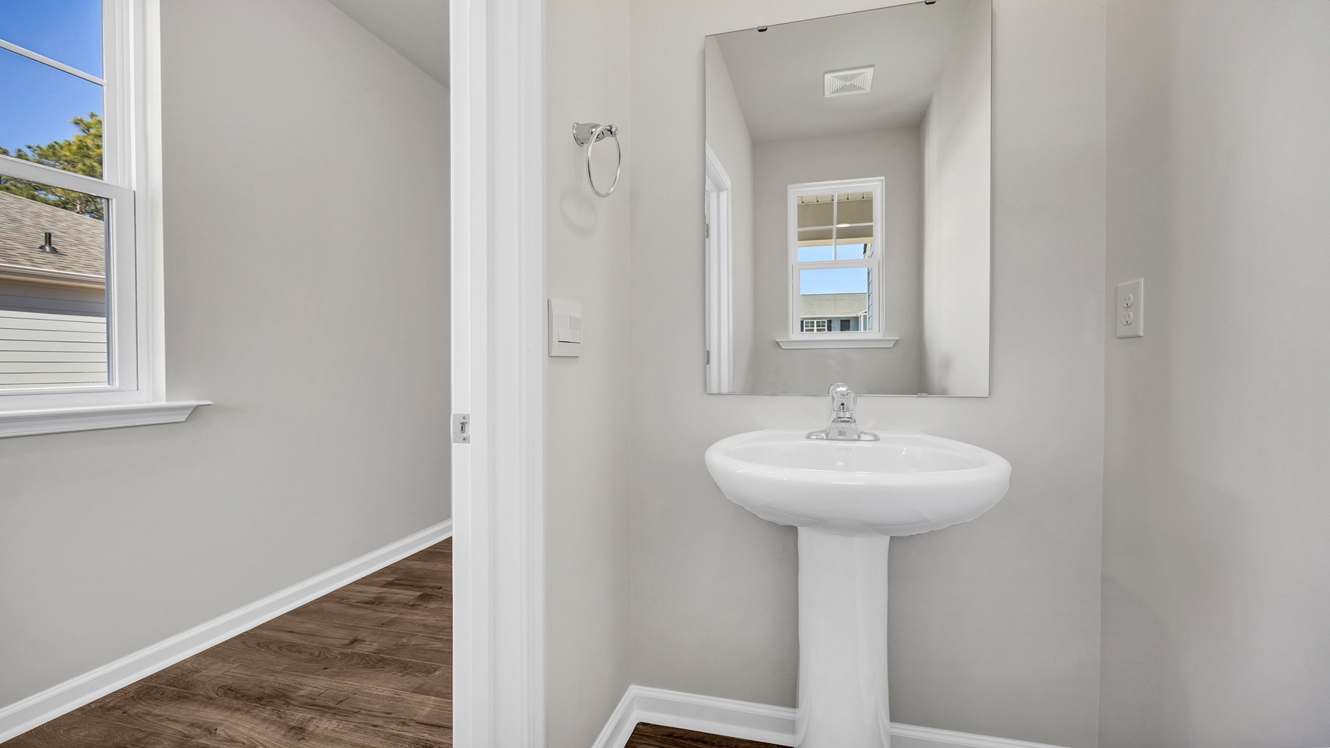 First-floor half bath powder room off the front foyer of the two-story home
