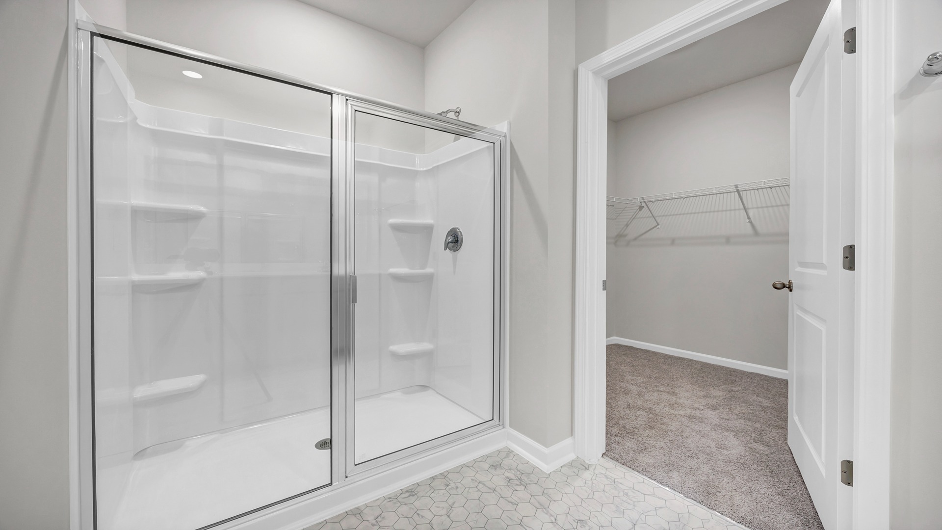 Standup walk-in primary shower with glass doors