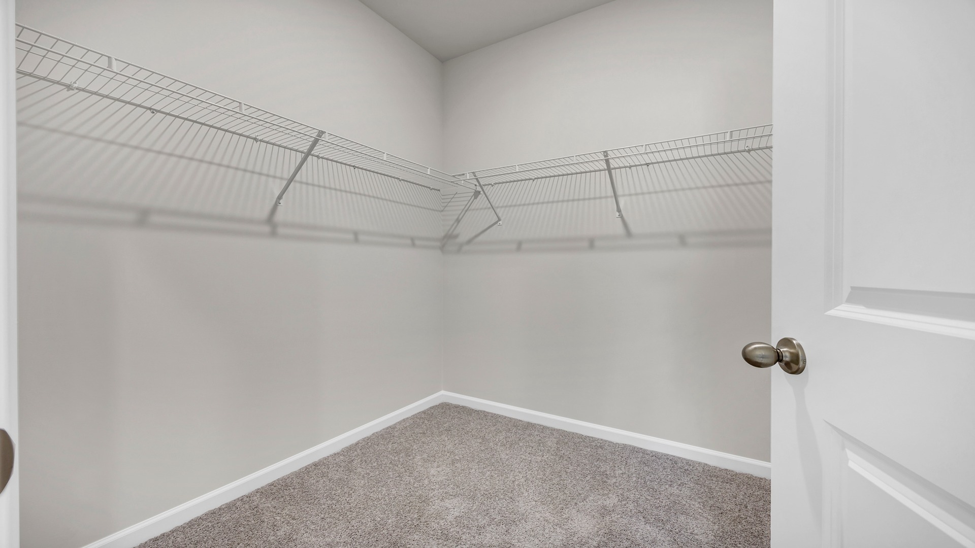 Walk-in primary closet in the bathroom with wire shelving