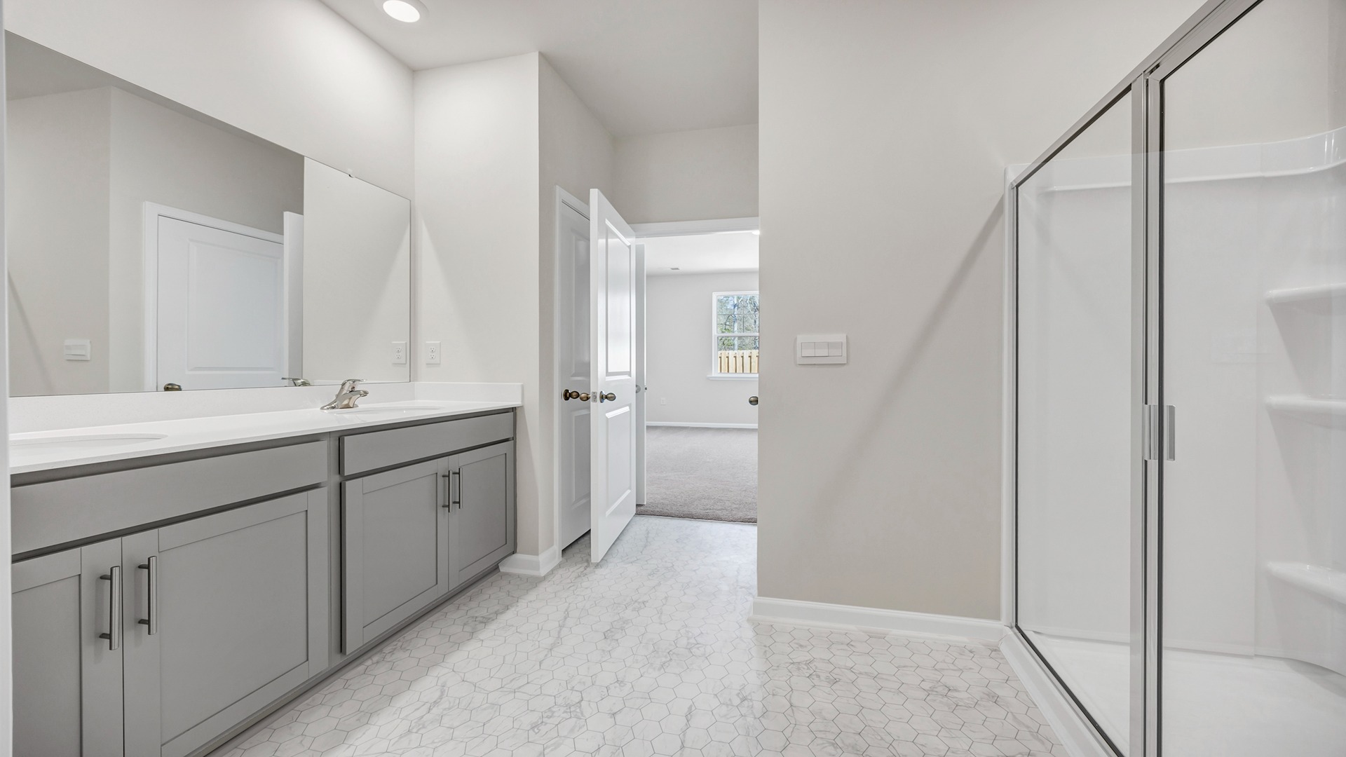 Double primary bathroom vanity with gray cabinets and quartz countertops