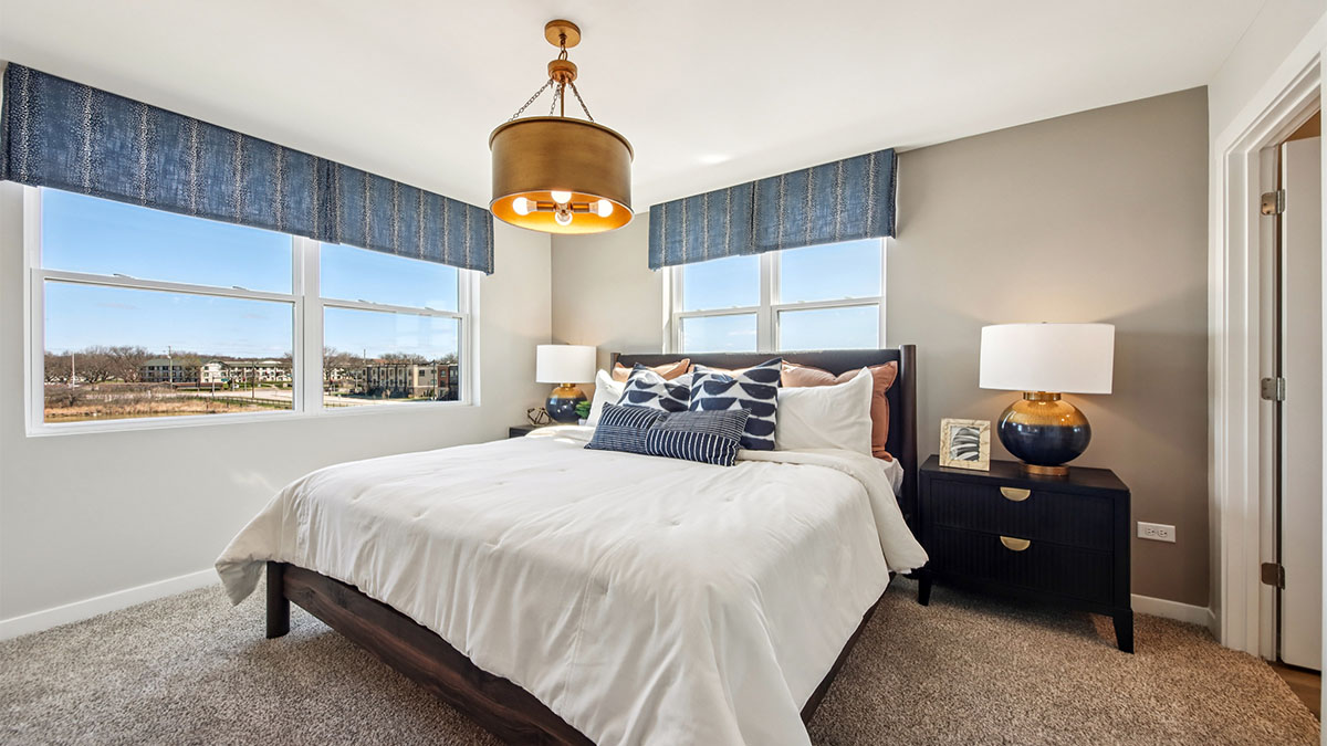 primary bedroom with large windows and natural light