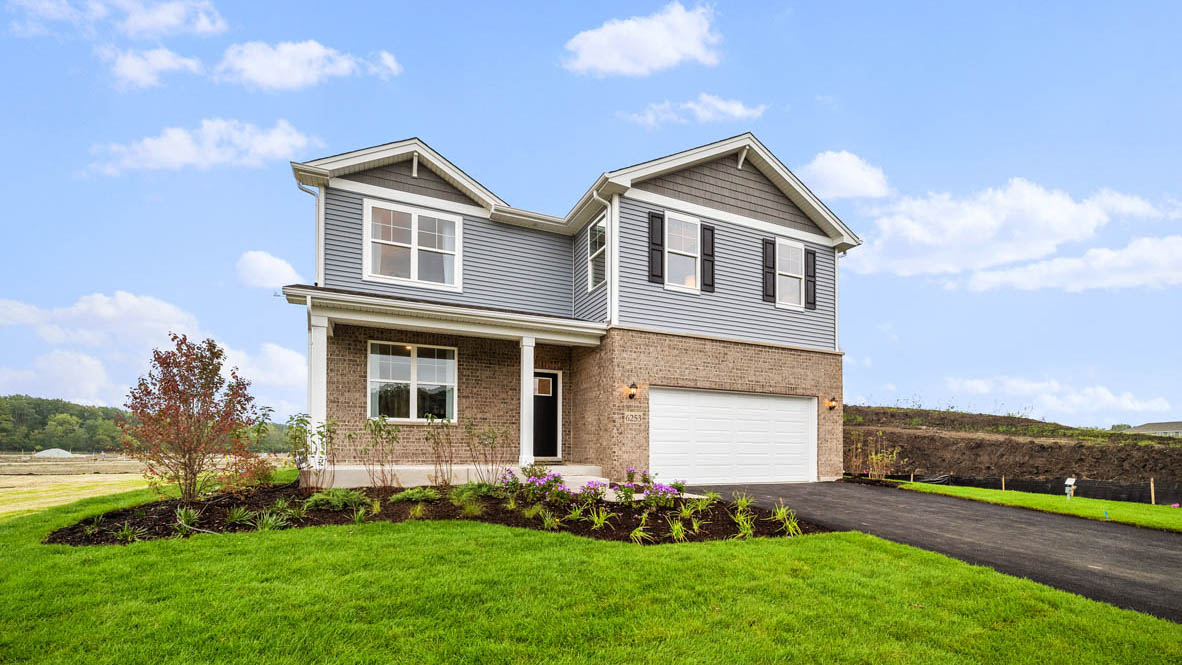 Exterior Henley Model with a front porch and brick and vinyl siding