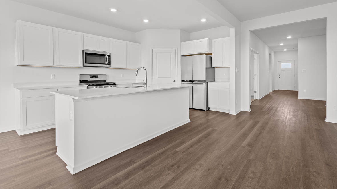 Hallway leading to open concept kitchen dining room and great room