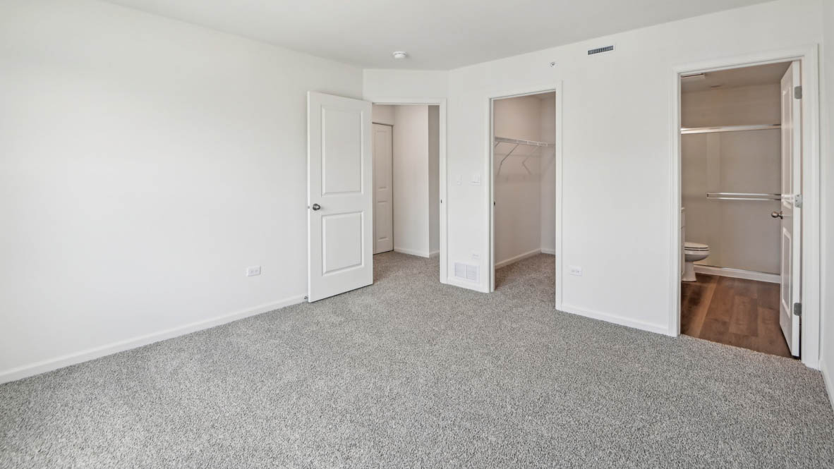 Primary bedroom with connecting en suite and walk in closet