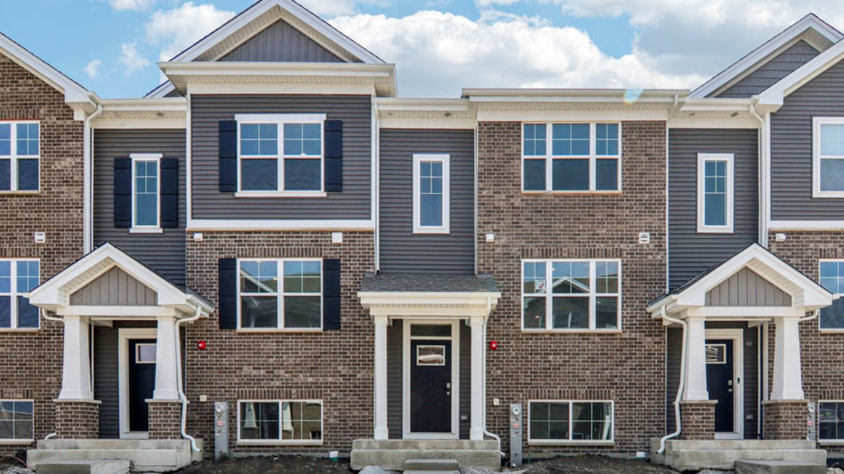 Tri level townhome with brick and vinyl siding