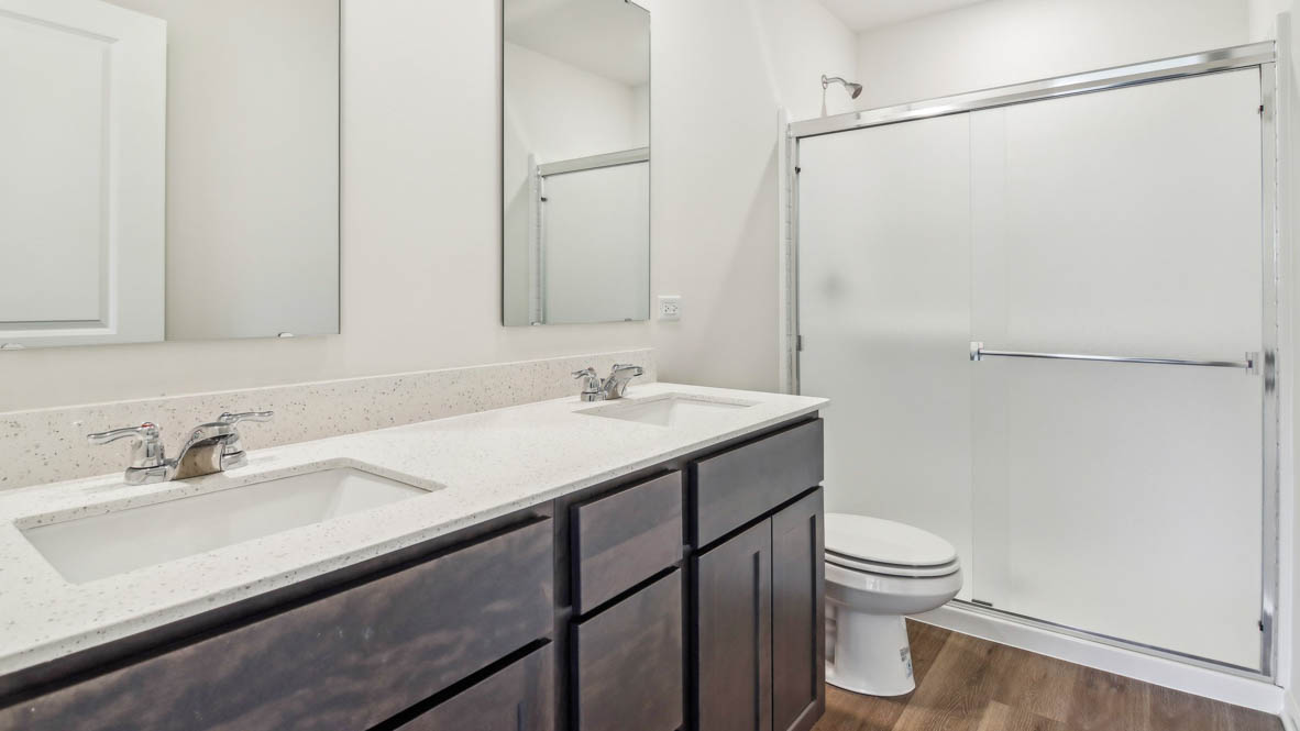 Primary bathroom with dual sinks and walk in shower