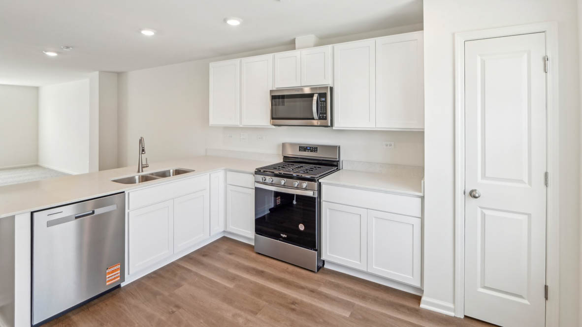 Kitchen with white cabinets and white quartz countertops