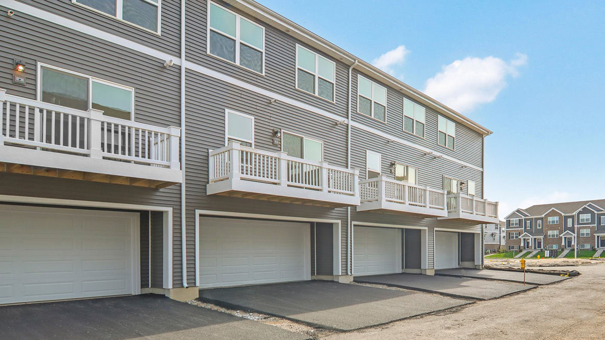Townhome back side with large balcony and white vinyl rails