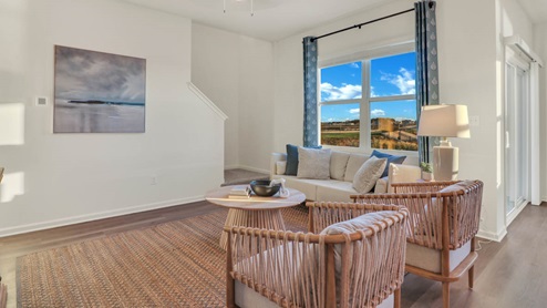 living room with access to stairs that lead to the upper level