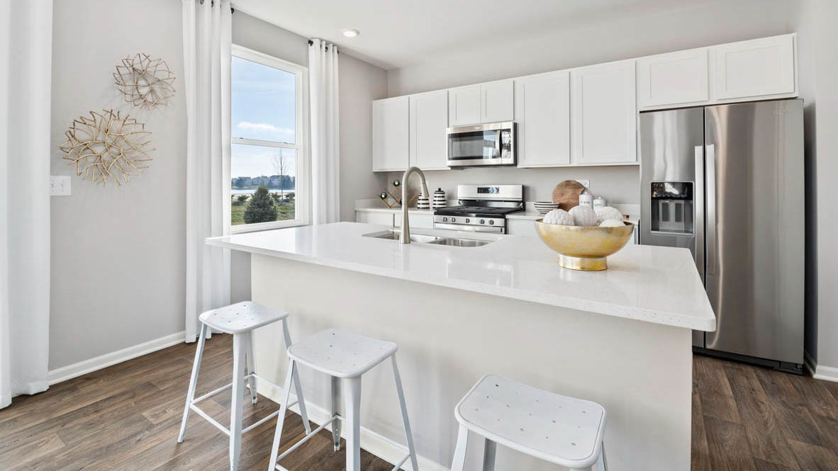 Kitchen with white quartz countertops and white cabinets