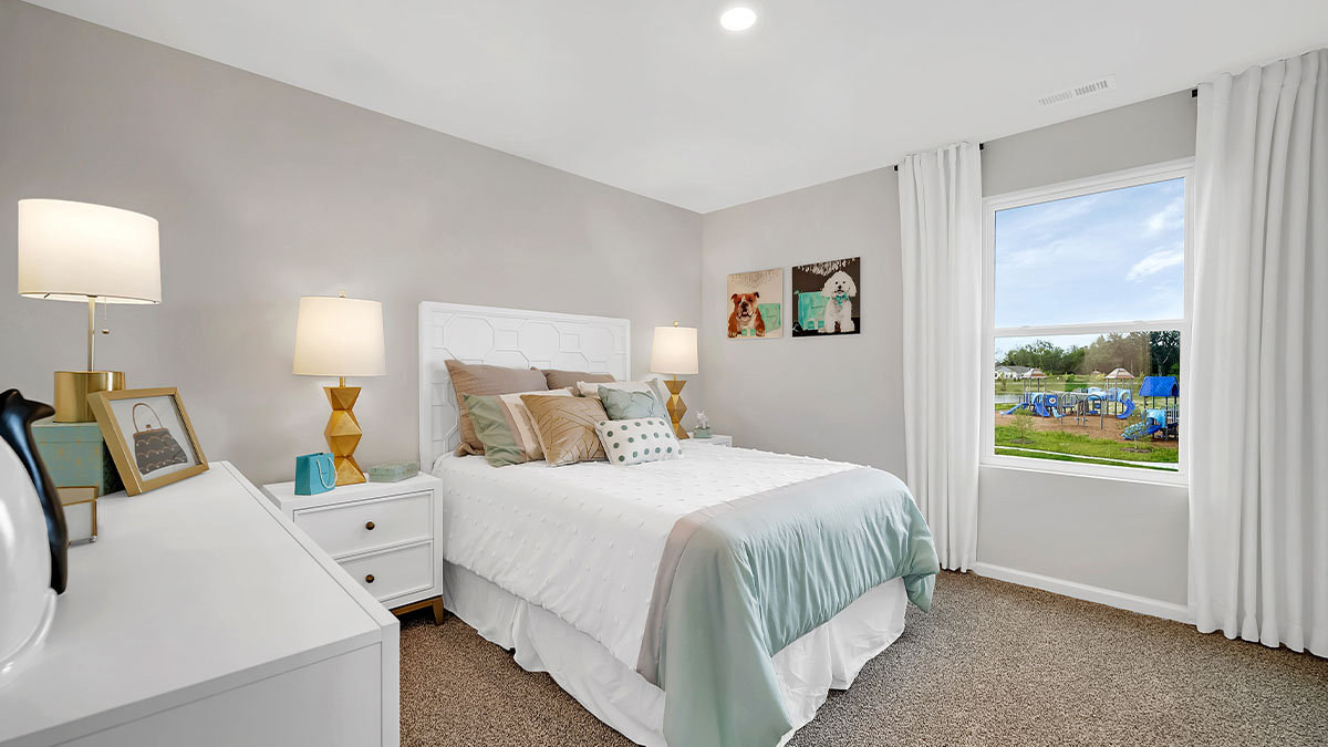 bedroom with white bedding, with white decor and a window