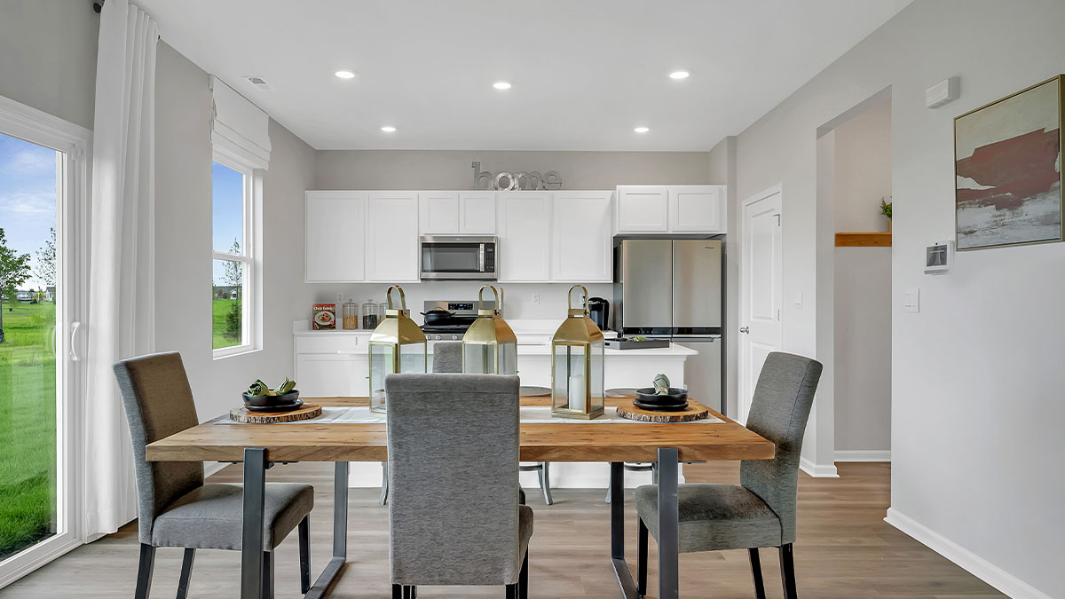 Dining room next to the kitchen featuring a table with six chairs
