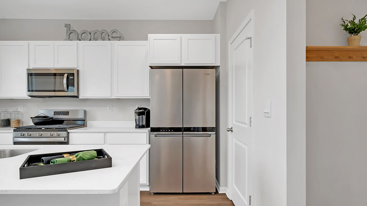 kitchen with white cabinetry, large island and stainless steel appliances