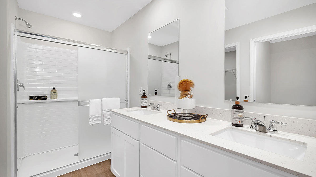 Primary bathroom with dual sinks and quartz countertops