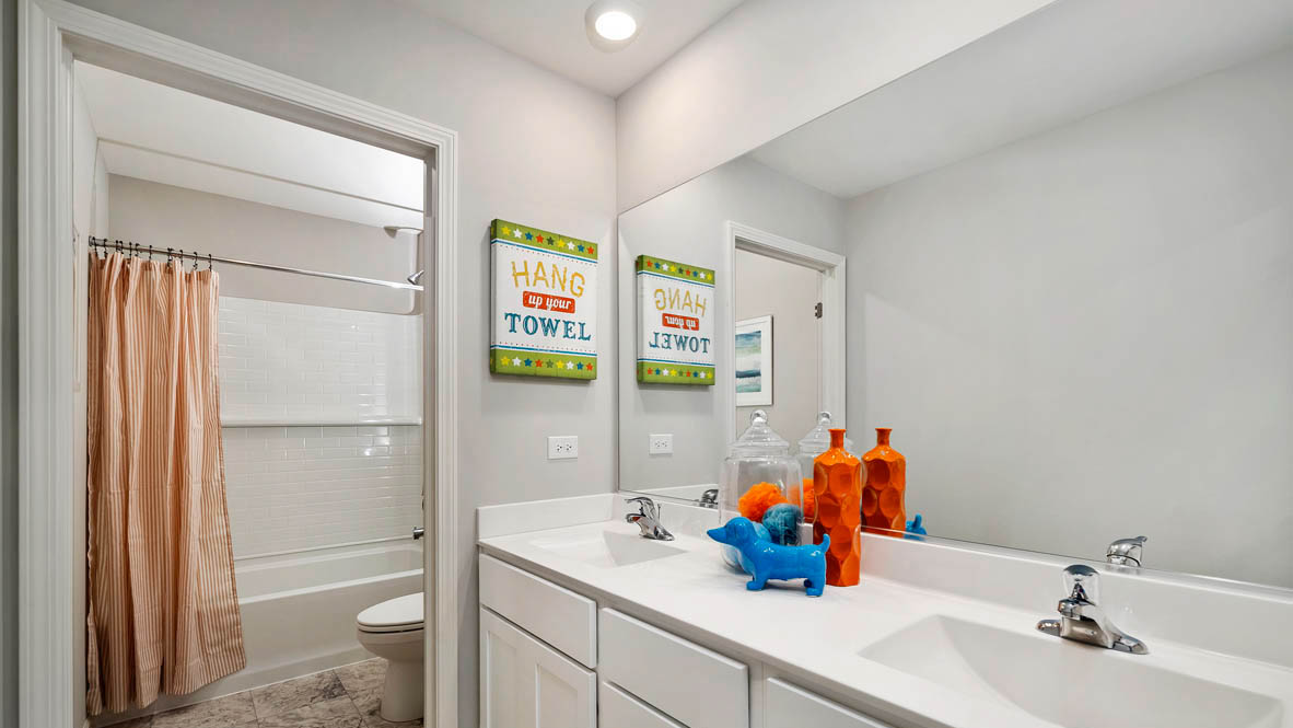 Full secondary bathroom with dual sinks and water closet