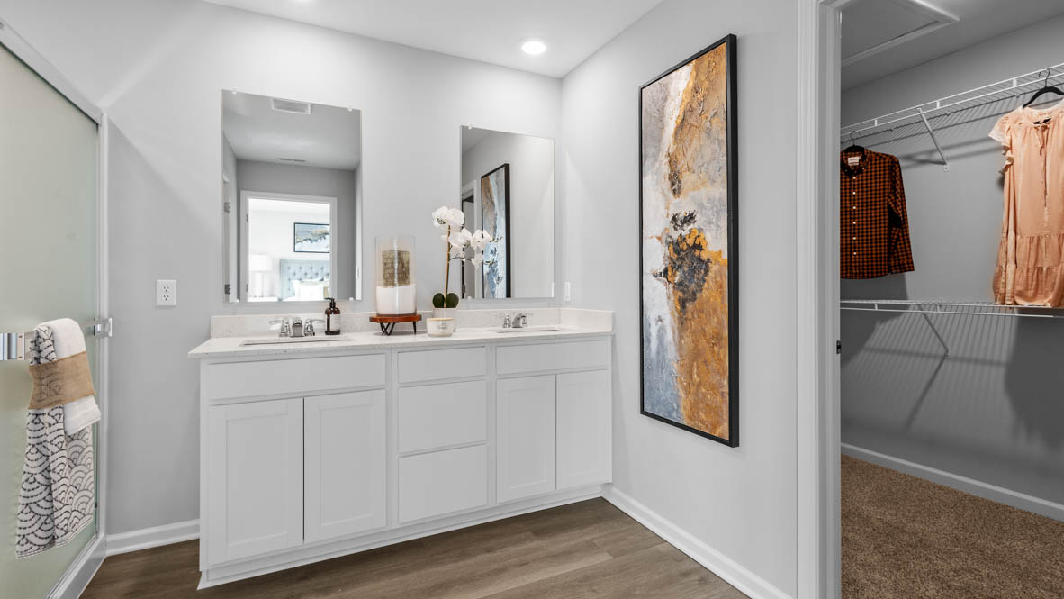 Primary bathroom with dual vanity and walk in closet