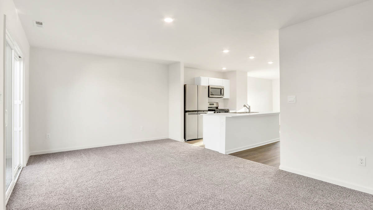 View from dining room into kitchen into living room and outdoor backyard access at Station Heights