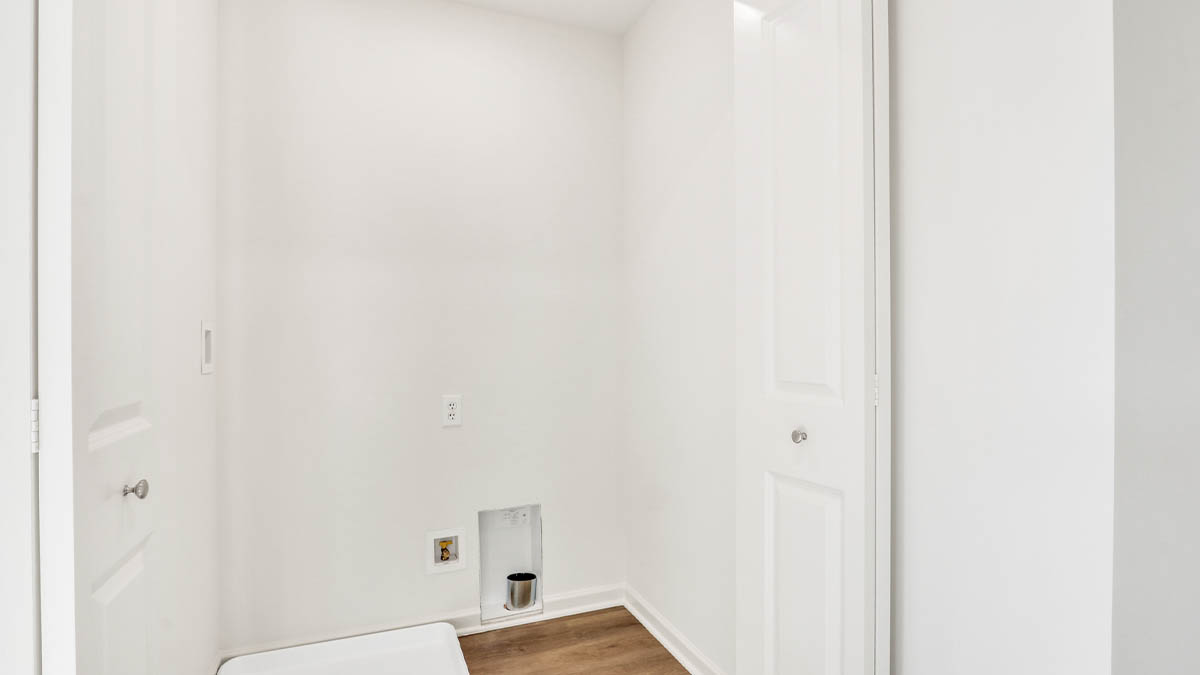 Sleek family-guest bath with single sink, mirror, cabinets, and shower-tub combination at Station Heights