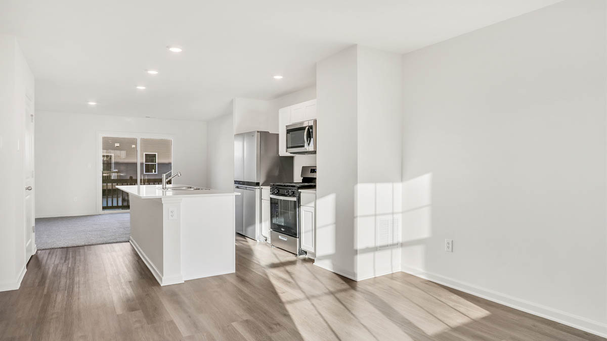 View from dining room into kitchen with island, pantry, new appliances and cabinet options
