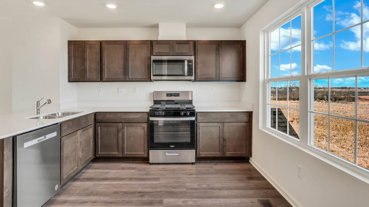 kitchen with dark cabinets and white quartz countertops