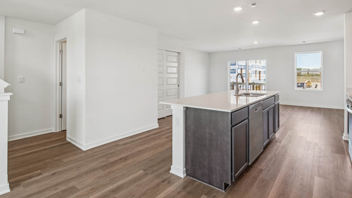 Functional kitchen island adds a sink, multi-prep zones, cabintes and a pantry, new appliance suite, and outside access