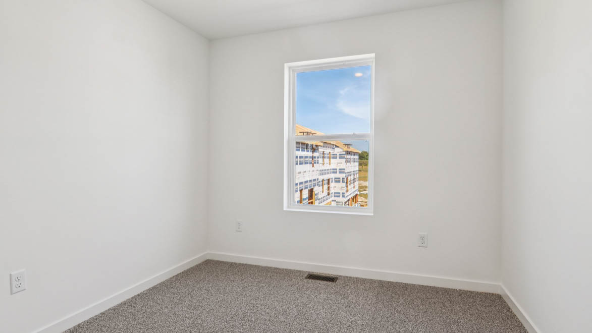 Secondary bedroom with full closet, direct access to shared upstairs spaces, loft multi-use areas