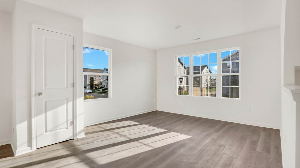 Primary bedroom features ample space, double windows, soft carpet, a stylish walk-in closet, private ensuite bath