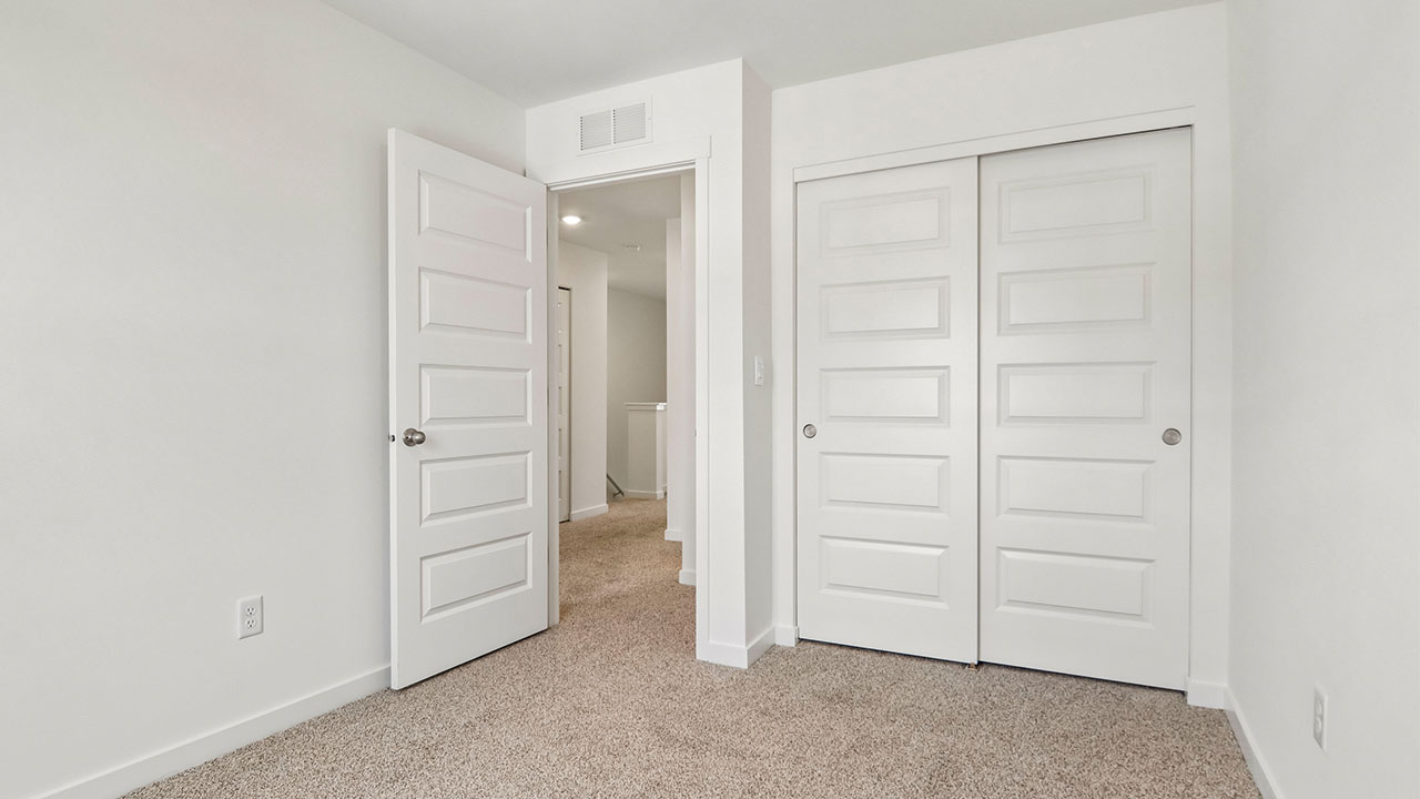 secondary bedroom with carpeted flooring