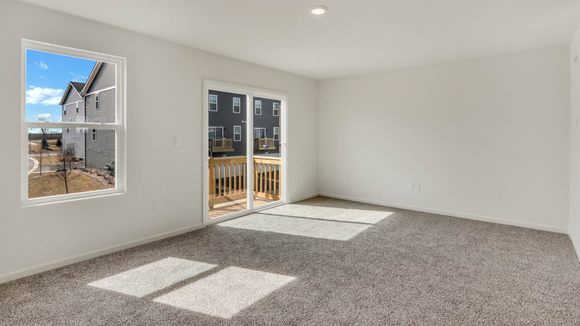 Great room on one side of kitchen with sliding door to balcony