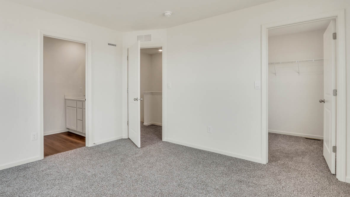 Primary bedroom with connecting en suite and walk in closet