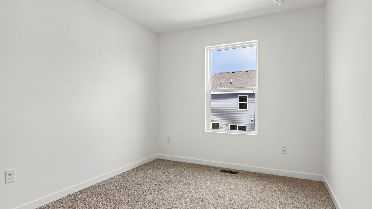 secondary bedroom with carpeted flooring