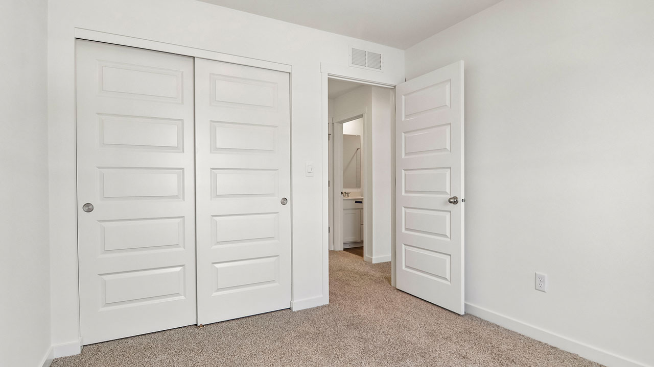 secondary bedroom with carpeted flooring
