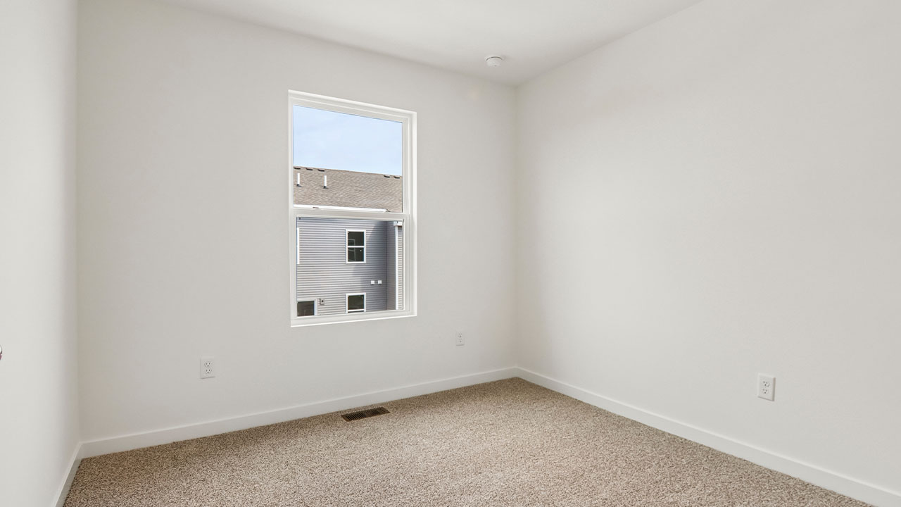 secondary bedroom with carpeted flooring