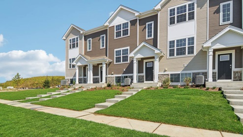Tri level townhome with vinyl and stone siding