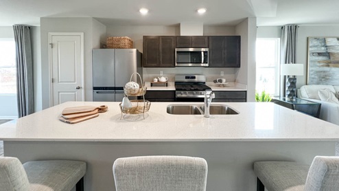 open concept kitchen with with dork cabinets