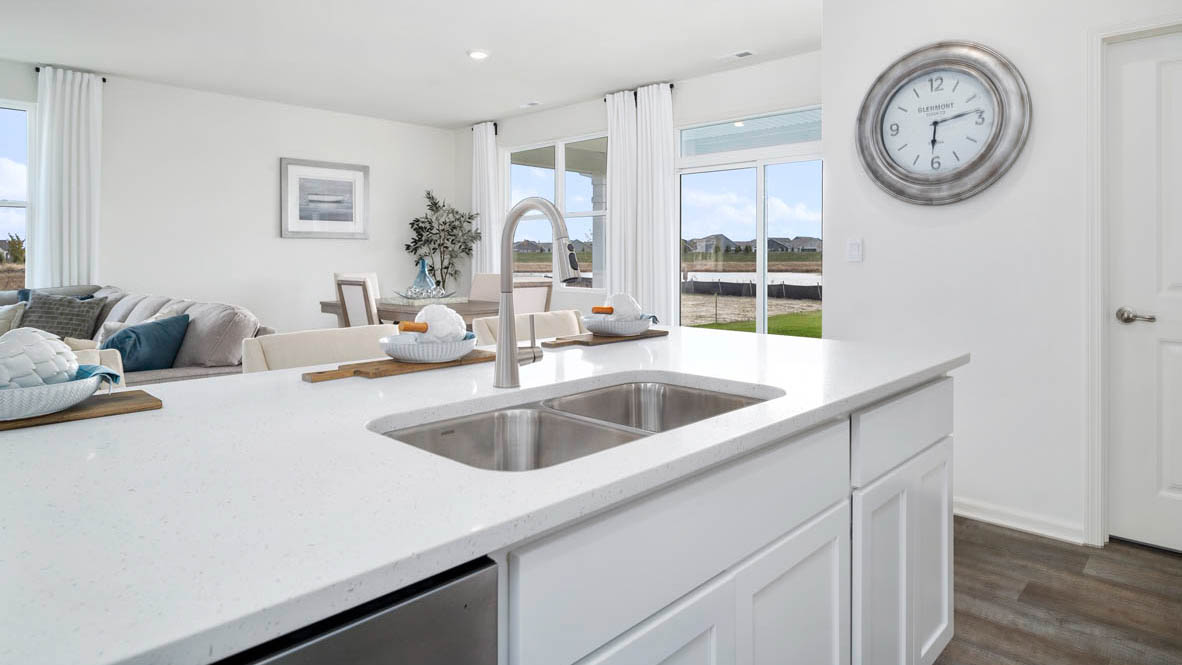 Large kitchen island overlooking great room and dining room