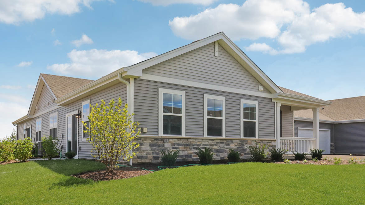 Ranch townhome with vinyl siding and stone accents
