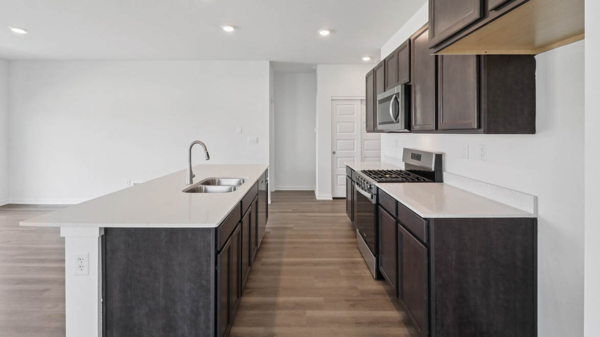 Large kitchen island over looking dining room and great room