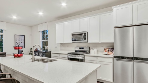 Kitchen with white cabinets and white quartz coutnertops