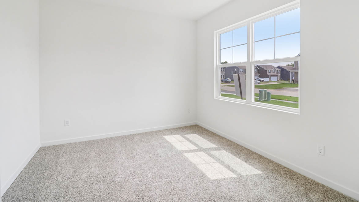Spacious flex room with large window and carpeted floor