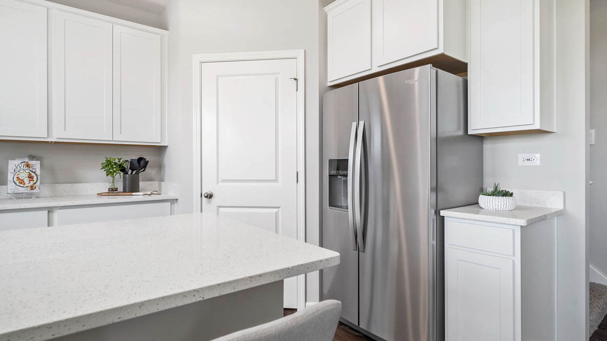 Kitchen with white cabinets and white quartz countertops