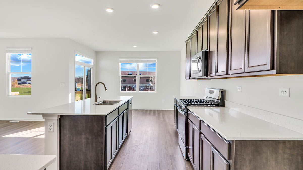 Kitchen with brown cabinets and white quartz countertops